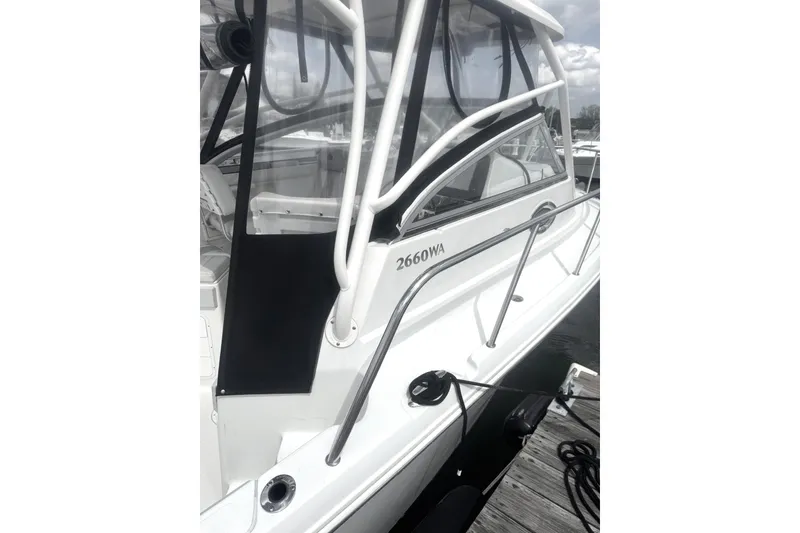 Slide: The Image of 2007 Sailfish 2660 WAC boat docked, showcasing sleek design and sturdy railings. - 3