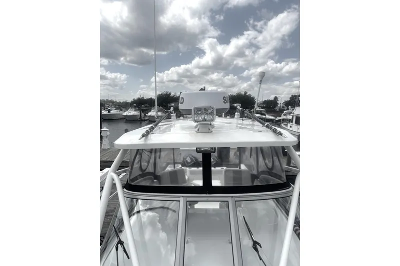 Slide: The Image of 2007 Sailfish 2660 WAC boat docked under cloudy sky. - 4