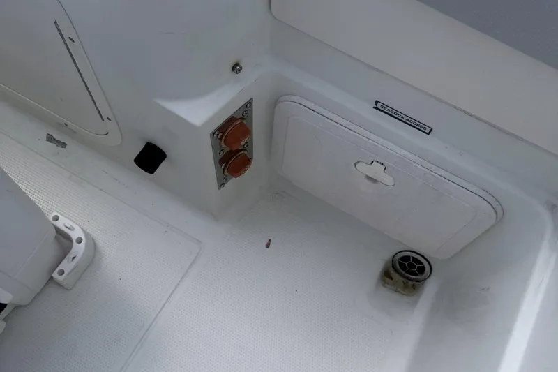 Slide: The Image of 2007 Sailfish 2660 WAC boat interior showing seacock access and drainage area. - 8