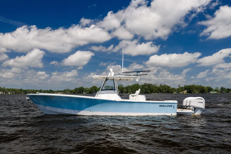 The Image of 2024 Regulator 34 boat on water under blue sky with clouds. - 1