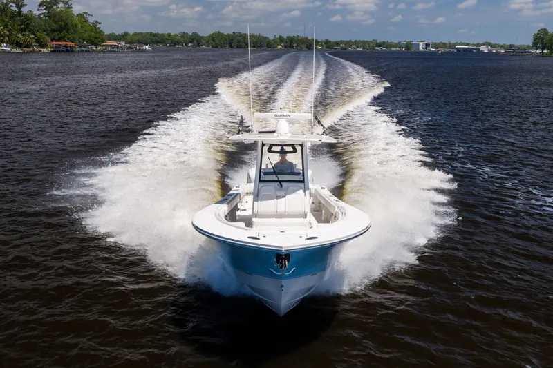 Slide: The Image of 2024 Regulator 34 boat cruising on a lake, creating a dynamic wake. - 10