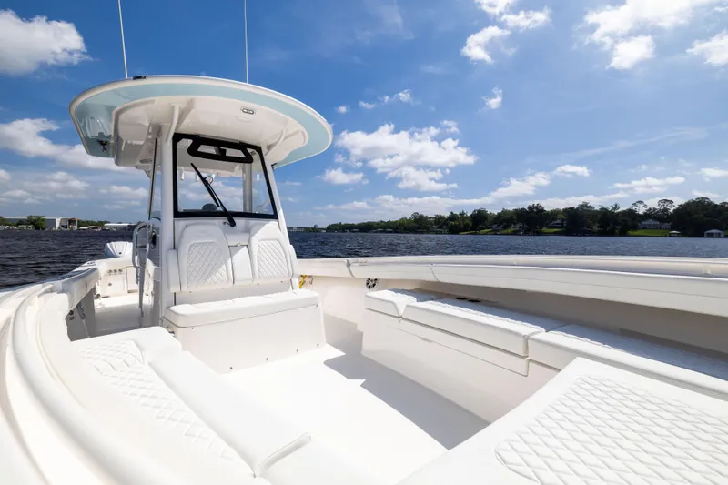 Slide: The Image of 2024 Regulator 34 boat on a sunny day, featuring spacious seating and sleek design. - 17
