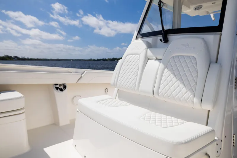 Slide: The Image of 2024 Regulator 34 boat with luxurious white seating and scenic water view. - 20