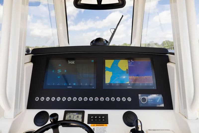 Slide: The Image of 2024 Regulator 34 boat dashboard with advanced navigation displays and controls. - 26