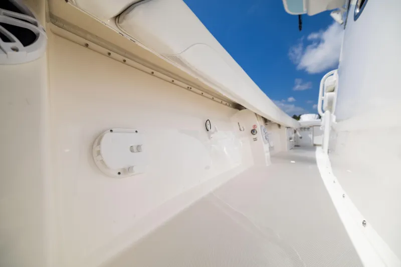 Slide: The Image of 2024 Regulator 34 boat interior with sleek white deck and blue sky background. - 27