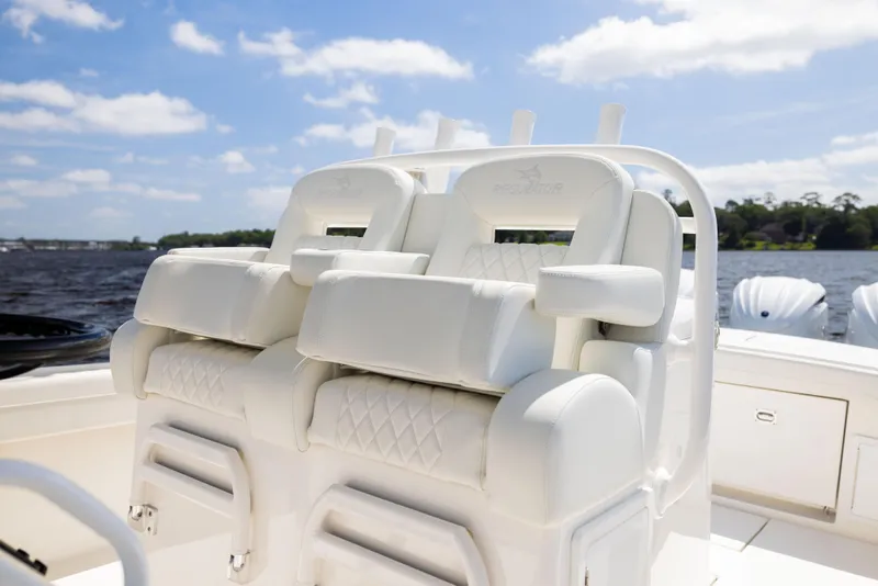 Slide: The Image of 2024 Regulator 34 boat with luxurious white seating, set against a scenic water backdrop. - 30