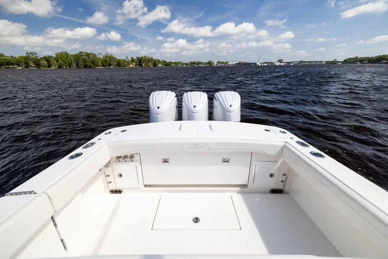 Slide: The Image of 2024 Regulator 34 boat with triple engines on a calm lake. - 40