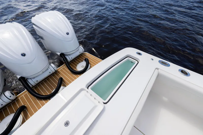 Slide: The Image of 2024 Regulator 34 boat with triple outboard engines on water. - 43