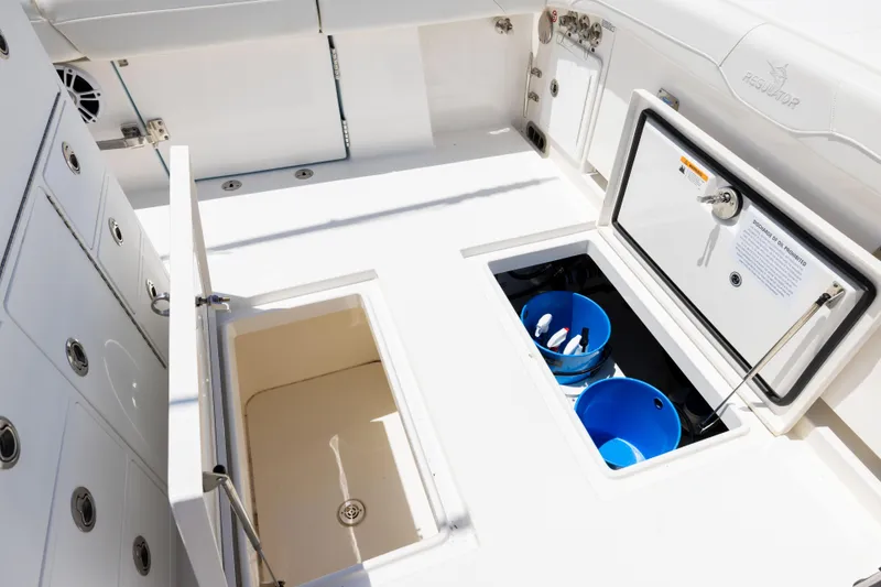 Slide: The Image of 2024 Regulator 34 boat deck with storage compartments and blue buckets. - 45