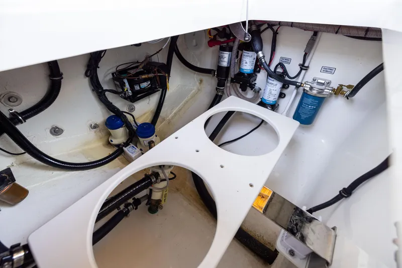 Slide: The Image of 2024 Regulator 34 boat engine compartment with wiring and filtration systems. - 48