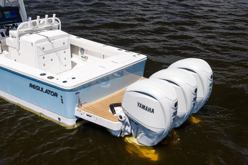 Slide: The Image of 2024 Regulator 34 boat with triple Yamaha outboard engines on water. - 5