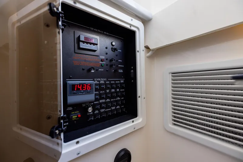 Slide: The Image of Electrical panel inside 2024 Regulator 34 boat, displaying voltage and controls. - 54