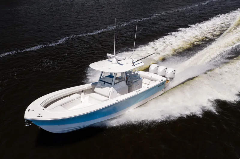 Slide: The Image of 2024 Regulator 34 boat cruising on water, showcasing sleek design and powerful engines. - 7