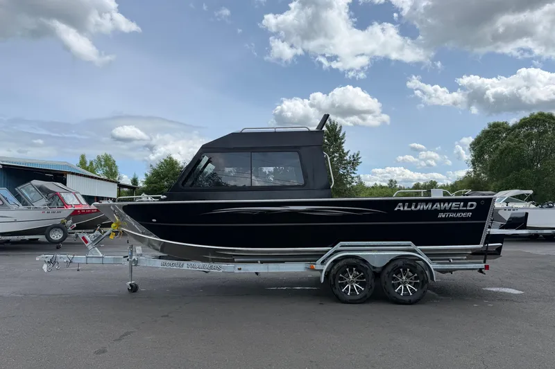 The Image of 2026 Alumaweld Intruder 22 HT boat on trailer, parked outdoors under cloudy sky. - 0