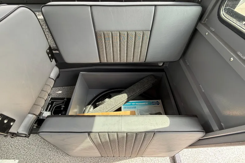 Slide: The Image of Storage compartment in 2026 Alumaweld Intruder 22 HT boat, featuring cushioned seating. - 15