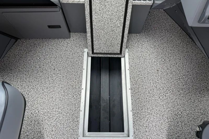 Slide: The Image of 2026 Alumaweld Intruder 22 HT interior with open storage compartment on speckled flooring. - 18