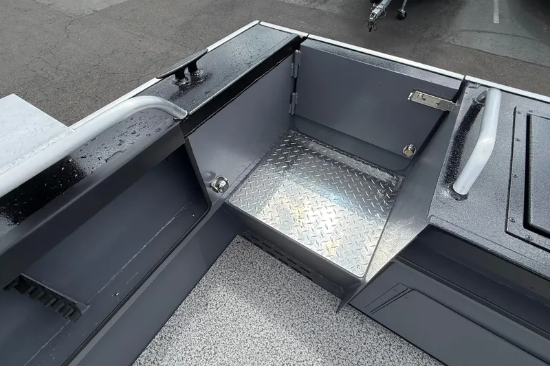 Slide: The Image of 2026 Alumaweld Intruder 22 HT boat interior with diamond plate flooring and storage compartments. - 26