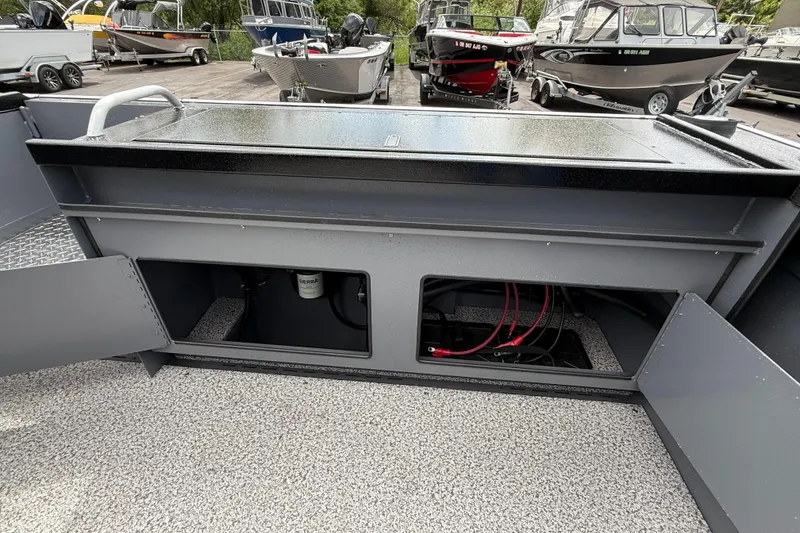 Slide: The Image of 2026 Alumaweld Intruder 22 HT boat interior with open storage compartments and visible wiring. - 27
