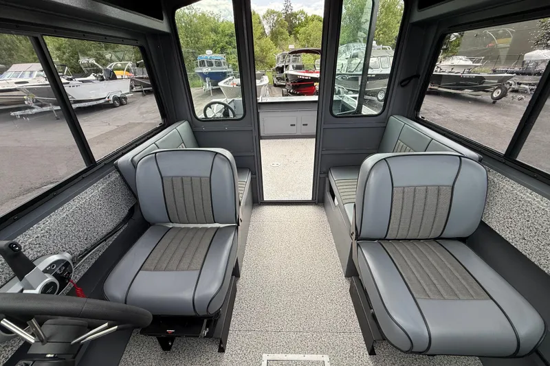 Slide: The Image of 2026 Alumaweld Intruder 22 HT interior with gray seating and spacious cabin design. - 32