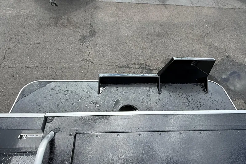 Slide: The Image of 2026 Alumaweld Intruder 22 HT boat deck with wet surface and metal railing. - 33