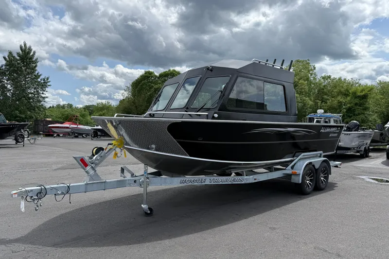 Slide: The Image of 2026 Alumaweld Intruder 22 HT boat on trailer, parked outdoors under cloudy sky. - 35