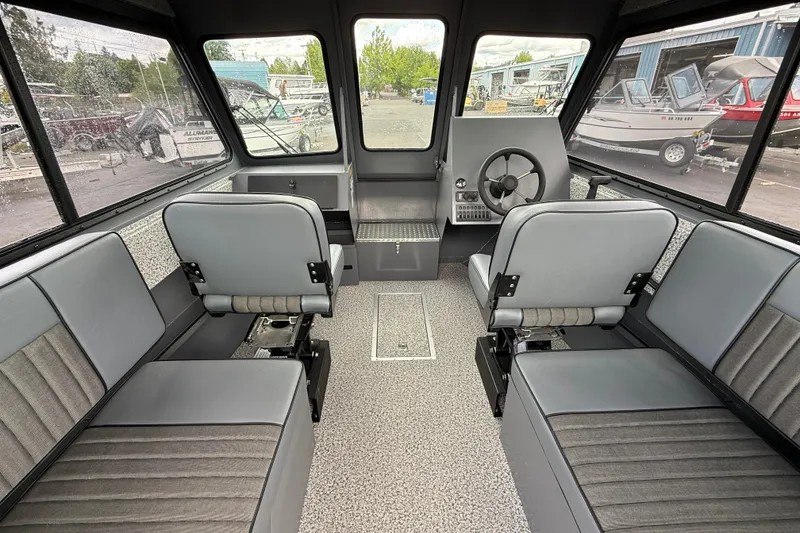Slide: The Image of 2026 Alumaweld Intruder 22 HT boat interior with gray seating and steering console. - 4