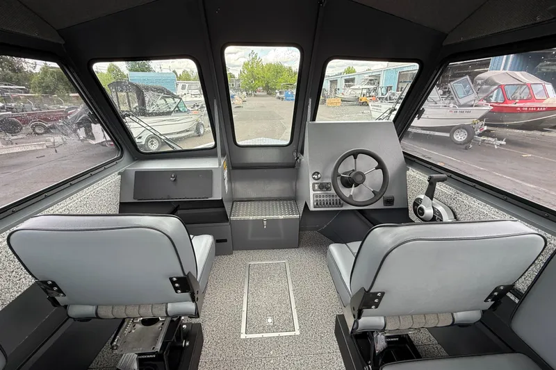Slide: The Image of Interior of 2026 Alumaweld Intruder 22 HT boat, featuring dual seats and steering console. - 5