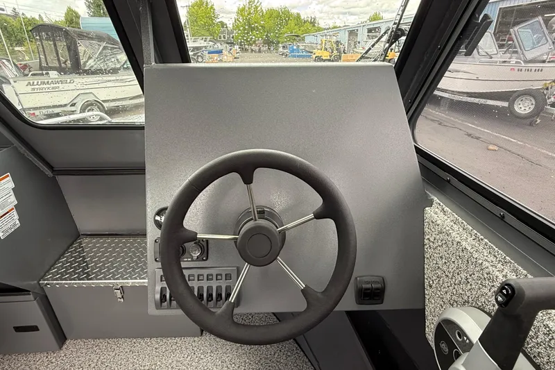 Slide: The Image of Steering console of 2026 Alumaweld Intruder 22 HT boat, featuring modern controls. - 7