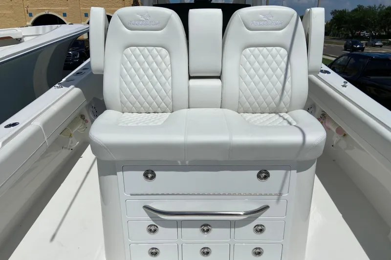 Slide: The Image of 2026 Regulator 31 boat with white cushioned seating and storage drawers. - 11