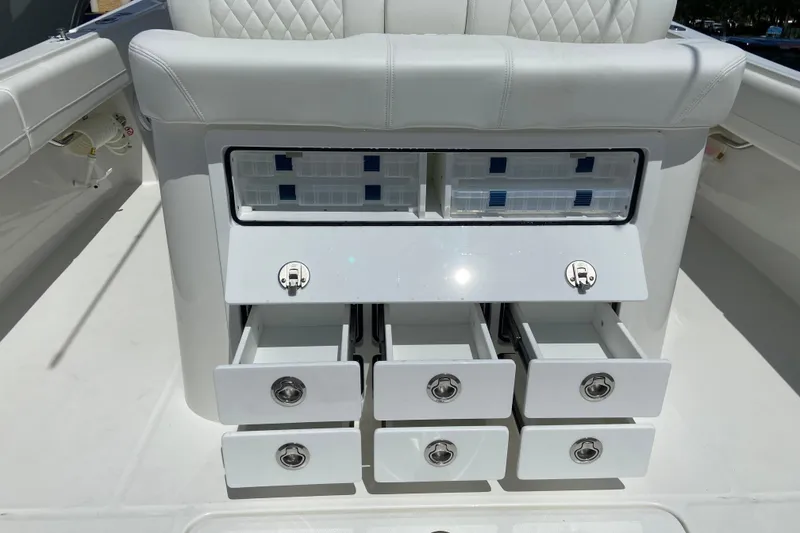 Slide: The Image of 2026 Regulator 31 boat storage drawers and compartments, featuring sleek white design and ample organization. - 13