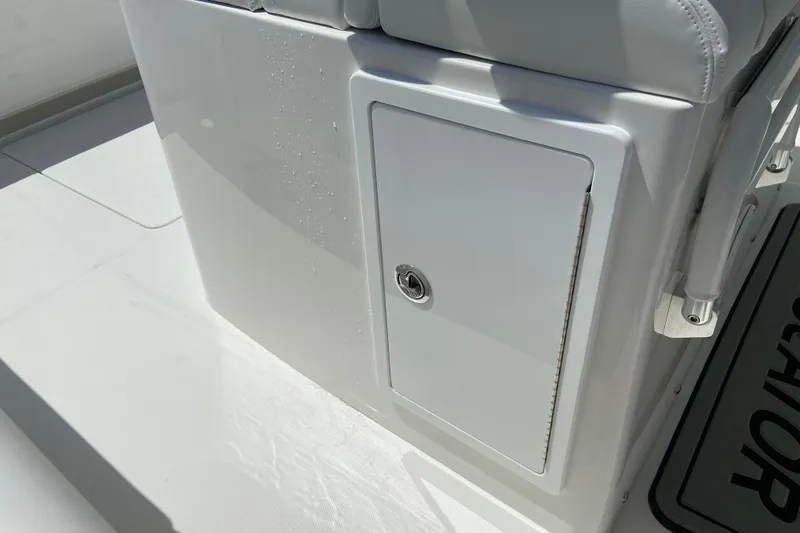 Slide: The Image of Storage compartment on a 2026 Regulator 31 boat, featuring sleek white design. - 16