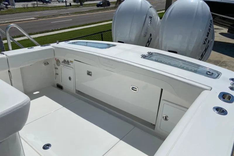 Slide: The Image of 2026 Regulator 31 boat interior with Yamaha engines, featuring sleek white design and storage compartments. - 2