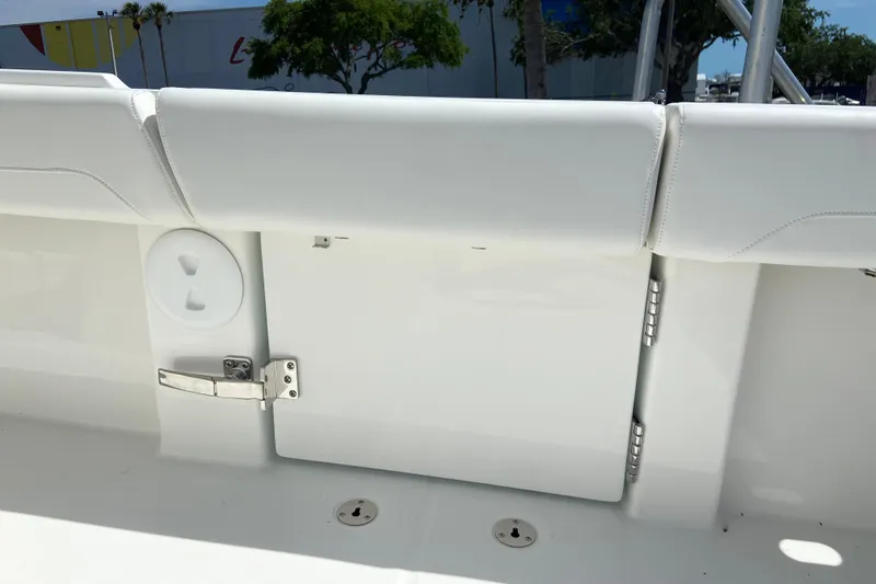 Slide: The Image of 2026 Regulator 31 boat interior with white seating and storage compartment. - 20