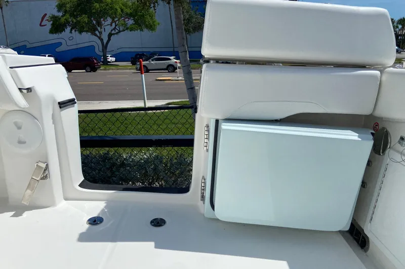 Slide: The Image of 2026 Regulator 31 boat interior with white seating and storage compartment. - 21
