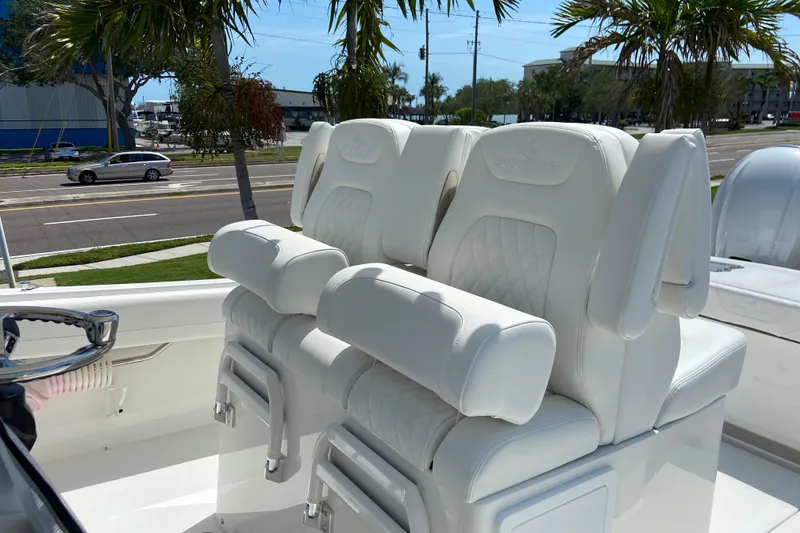 Slide: The Image of Luxury seating on 2026 Regulator 31 boat, featuring white cushioned captain's chairs. - 22