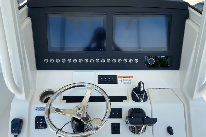 Slide: The Image of 2026 Regulator 31 boat dashboard with dual Garmin screens and modern controls. - 25