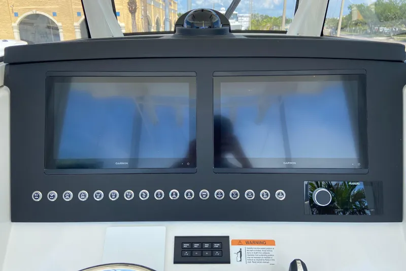 Slide: The Image of 2026 Regulator 31 boat dashboard with dual Garmin displays and control buttons. - 26