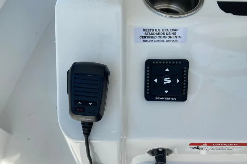 Slide: The Image of Control panel of a 2026 Regulator 31 boat featuring Garmin and Seakeeper devices. - 27
