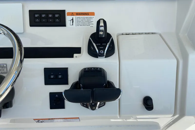 Slide: The Image of Control panel of a 2026 Regulator 31 boat with steering and throttle controls. - 28