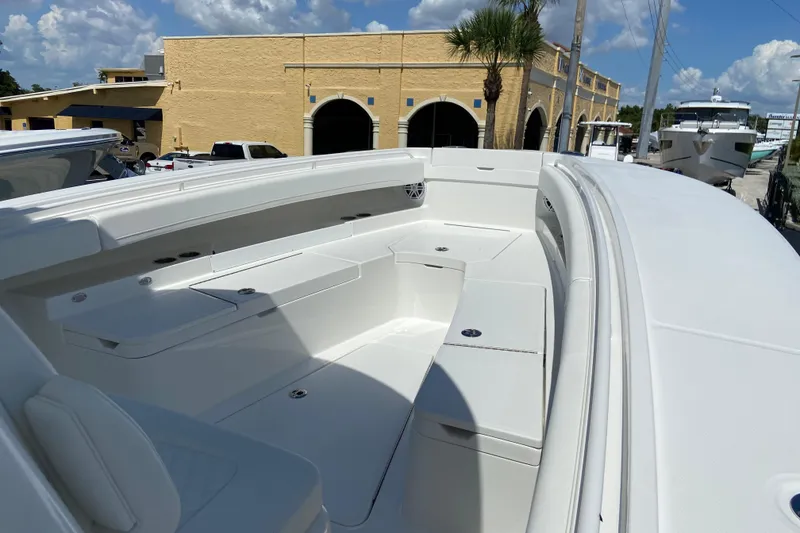Slide: The Image of 2026 Regulator 31 boat interior with white seating and storage compartments. - 32