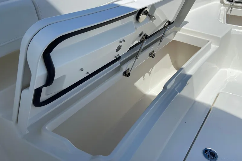 Slide: The Image of 2026 Regulator 31 boat storage compartment with open lid and hydraulic supports. - 35