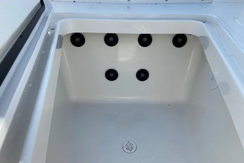 Slide: The Image of 2026 Regulator 31 boat storage compartment with drainage holes. - 37