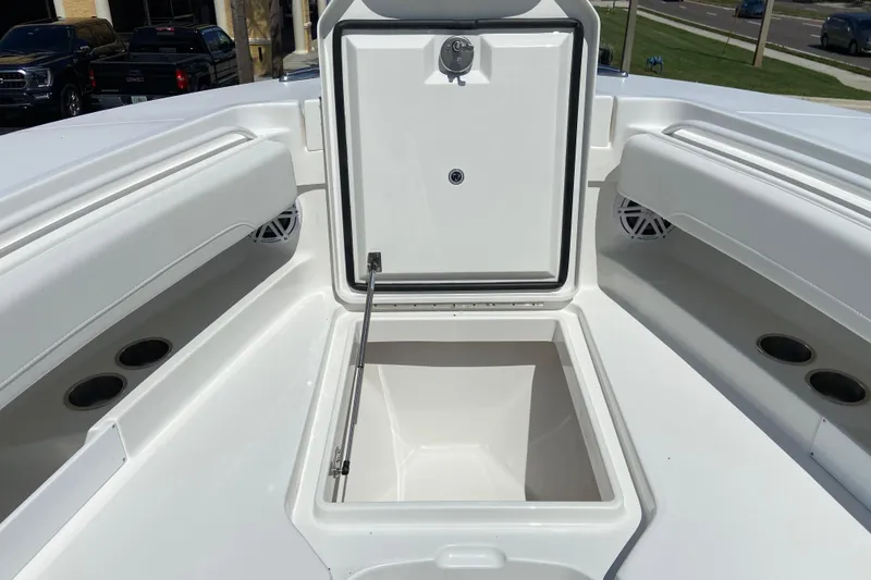 Slide: The Image of 2026 Regulator 31 boat with open storage compartment, showcasing sleek white interior design. - 38