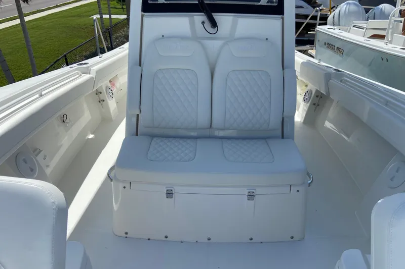 Slide: The Image of 2026 Regulator 31 boat interior with white cushioned seating and storage compartment. - 41