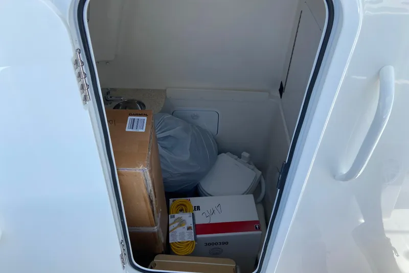 Slide: The Image of Storage compartment of 2026 Regulator 31 boat with various items inside. - 44
