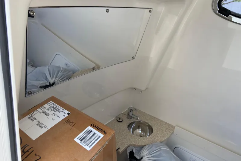 Slide: The Image of Interior of a 2026 Regulator 31 boat with a sink and packaged items. - 45
