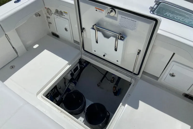 Slide: The Image of Open hatch on 2026 Regulator 31 boat, revealing storage and equipment compartments. - 8