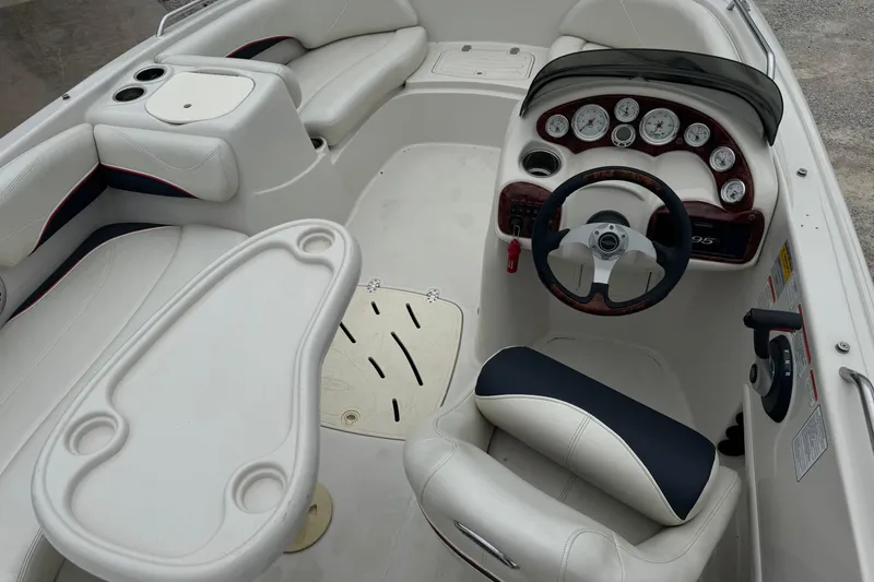 Slide: The Image of Interior of a 2015 Tahoe 195 boat featuring steering wheel and seating area. - 7