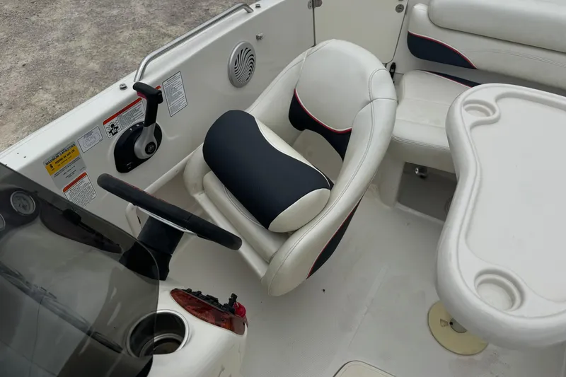 Slide: The Image of Interior of a 2015 Tahoe 195 boat featuring steering wheel and seating area. - 8