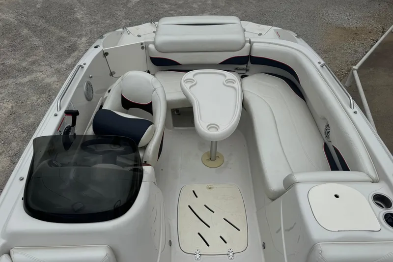 Slide: The Image of 2015 Tahoe 195 boat interior with white seating and table. - 9